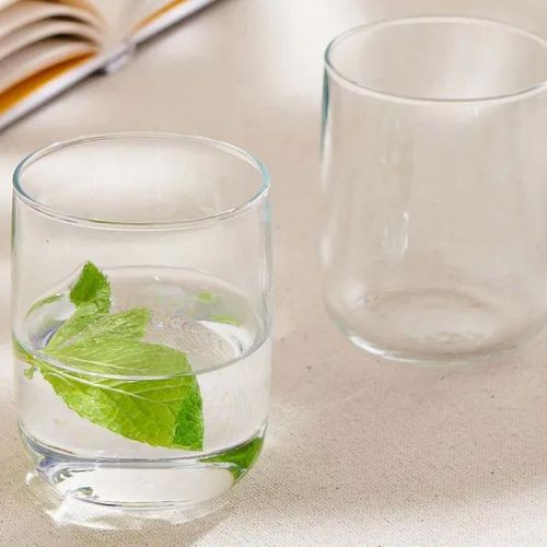 Iconic Tumbler 27 cl. Glas mit Getränk und gedrucktem Logo, platziert in modernem Ambiente Raum.